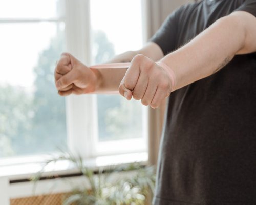 Person doing warm up stretches with a light resistance band